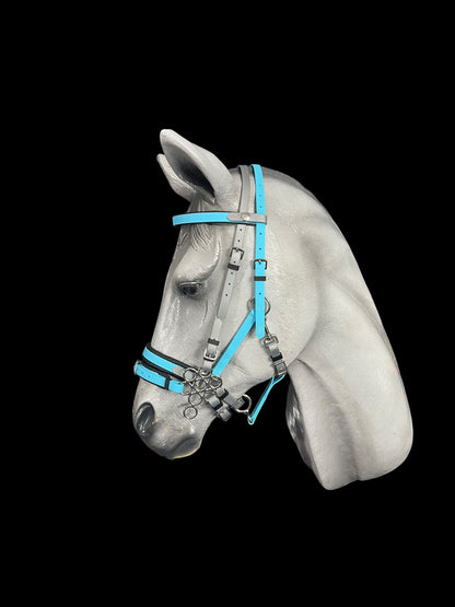 The sculpture of a horse's head showcases an LS Deux 2 Part Bridle Padded by LS Equestrian, custom-designed in turquoise and gray Beta BioThane, handmade in New Zealand, all set against a black background.