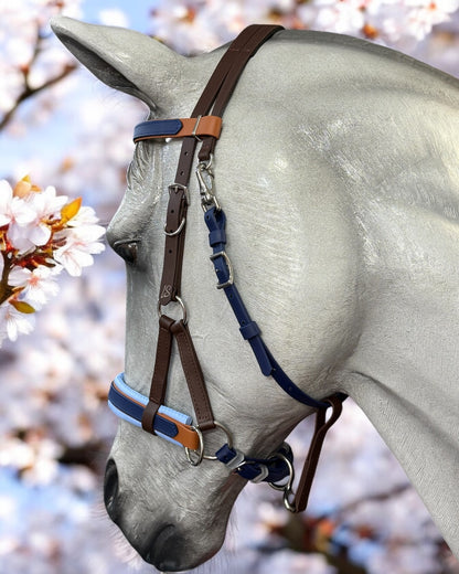 A horse wears an LS Equestrian SidePull Bitless Bridle Option 2 in custom brown and blue leather with a striped noseband, set against a backdrop of white cherry blossoms for a serene and elegant atmosphere.